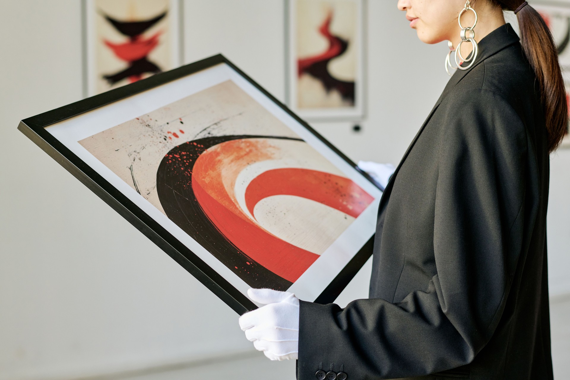 Holding Framed Abstract Painting in Art Gallery